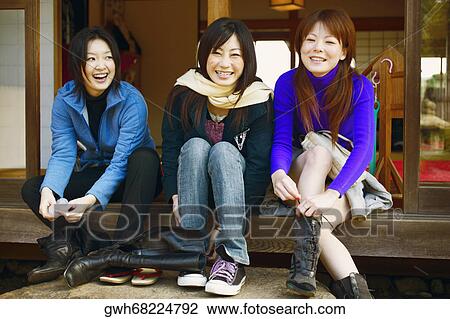 Three young women tying their shoe laces View Large Photo Image Stock Image - Three young women tying their shoe laces . Fotosearch
