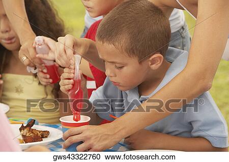 Two boys and a girl drinking from a cup View Large Photo Image Stock Image - Two boys and a girl drinking from a cup. Fotosearch