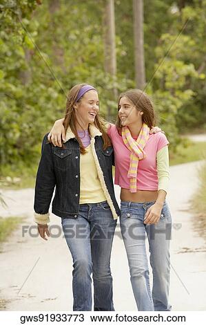 Two girls with their arms around each other View Large Photo Image Stock Image - Two girls with their arms around each other. Fotosearch