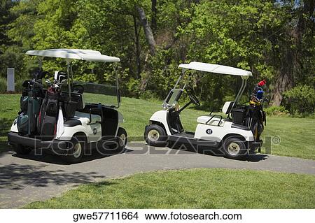 Two golf carts on a path View Large Photo Image Picture - Two golf carts on a path. Fotosearch