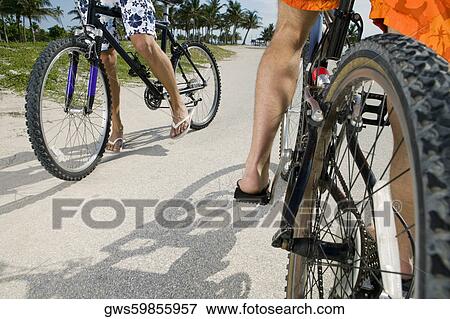 Stock Photo - Two men cycling on the road. Fotosearch