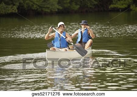 Two mid adult men canoeing View Large Photo Image Stock Photograph - Two mid adult men canoeing. Fotosearch