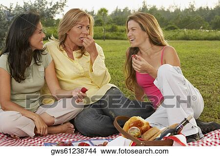 Two mid adult women and a mature woman at a picnic View Large Photo Image Picture - Two mid adult women and a mature woman at a picnic. Fotosearch