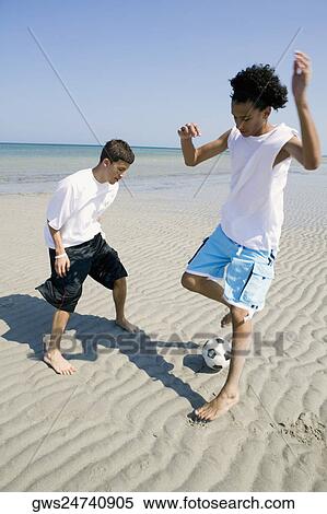 Two teenage boys playing with a soccer ball on the beach View Large Photo Image Stock Photography - Two teenage boys playing with a soccer ball on the beach. Fotosearch