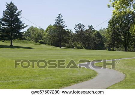 Walkway running through a golf course View Large Photo Image Stock Image - Walkway running through a golf course. Fotosearch