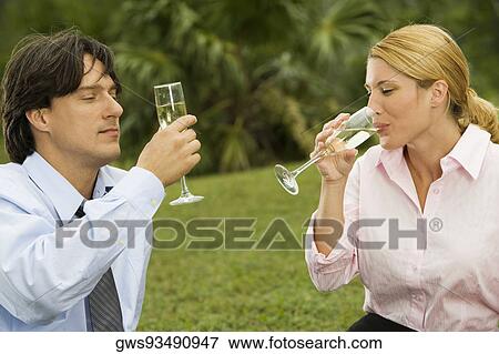 Young couple holding champagne flutes View Large Photo Image Stock Photo - Young couple holding champagne flutes. Fotosearch