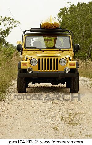 Young couple in a jeep View Large Photo Image Stock Image - Young couple in a jeep. Fotosearch