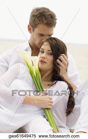Young couple romancing on the beach View Large Photo Image Stock Photography - Young couple romancing on the beach. Fotosearch