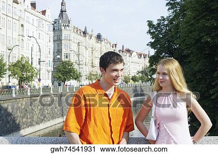 Young couple standing together View Large Photo Image Stock Image - Young couple standing together . Fotosearch