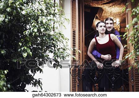Young man embracing a young woman from behind View Large Photo Image Stock Image - Young man embracing a young woman from behind . Fotosearch