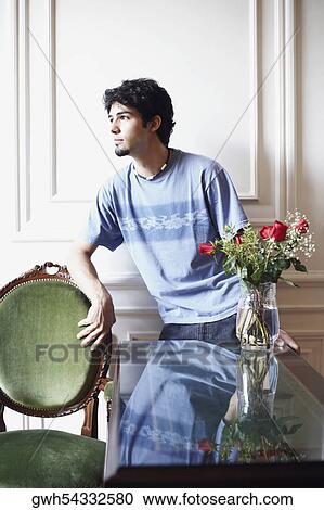 Young man leaning against a wall View Large Photo Image Stock Image - Young man leaning against a wall. Fotosearch