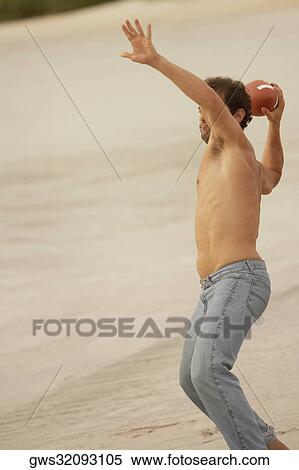 Young man throwing a football View Large Photo Image Stock Photography - Young man throwing a football. Fotosearch