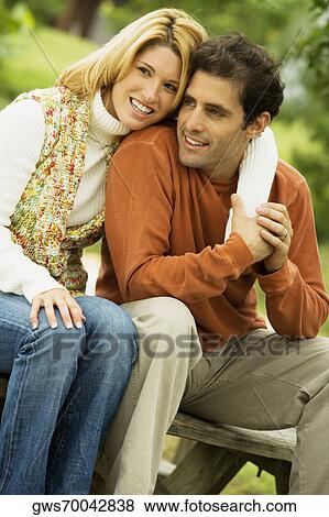 Young woman and a mid adult man sitting together View Large Photo Image Stock Photo - Young woman and a mid adult man sitting together. Fotosearch