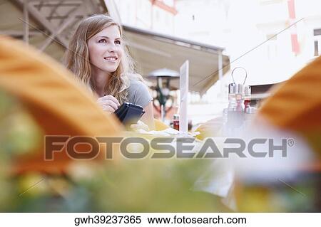 Young woman holding a personal data assistant View Large Photo Image Stock Photography - Young woman holding a personal data assistant . Fotosearch