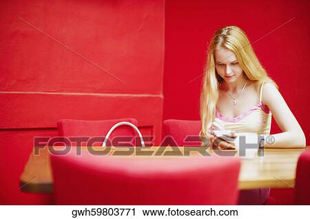 Young woman sitting in a restaurant  View Large Photo Image Stock Image - Young woman sitting in a restaurant . Fotosearch
