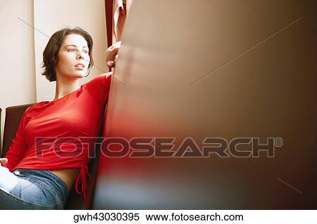 Stock Photography - Young woman sitting. Fotosearch