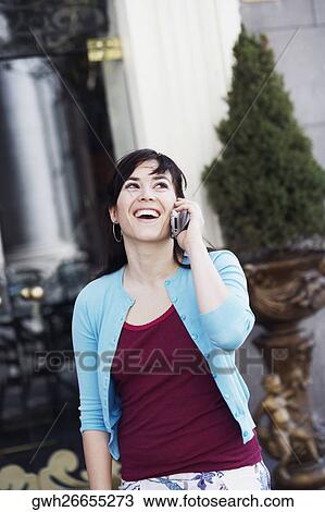 Stock Image - Young woman talking on a mobile phone . Fotosearch