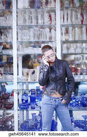 Stock Image - Young woman talking on a mobile phone . Fotosearch