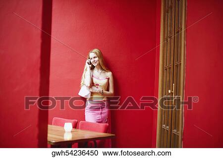 Young woman talking on a mobile phone View Large Photo Image Stock Image - Young woman talking on a mobile phone . Fotosearch