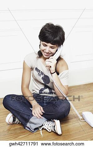 Young woman talking on the telephone View Large Photo Image Stock Image - Young woman talking on the telephone. Fotosearch