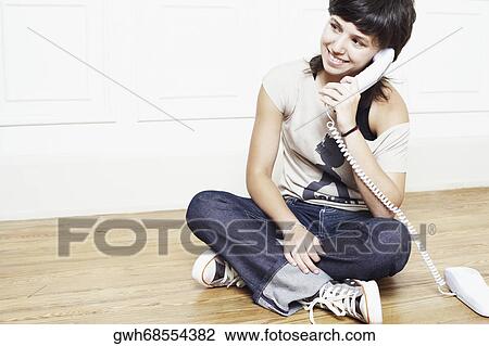 Young woman talking on the telephone View Large Photo Image Stock Image - Young woman talking on the telephone. Fotosearch