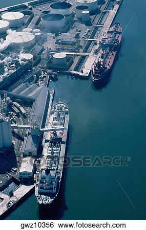 Aerial shot of ships at an oil refinery View Large Photo Image Stock Photograph - Aerial shot of ships at an oil refinery. Fotosearch