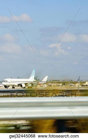 Airplane taking off at an airport runway, Miami, Florida, USA View Large Photo Image Stock Photo - Airplane taking off at an airport runway, Miami, Florida, USA. Fotosearch
