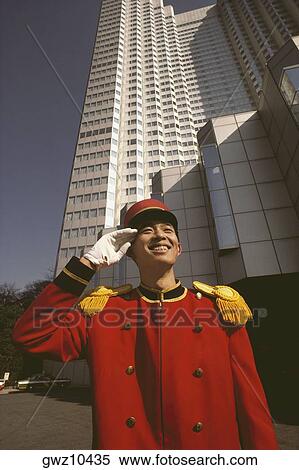 Bellhop saluting in front of a hotel, Tokyo Prefecture, Japan View Large Photo Image Stock Photography - Bellhop saluting in front of a hotel, Tokyo Prefecture, Japan. Fotosearch