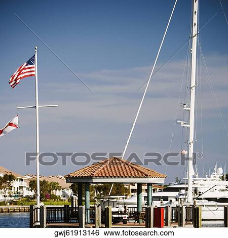 Boats docked at a harbor View Large Photo Image Stock Photograph - Boats docked at a harbor. Fotosearch