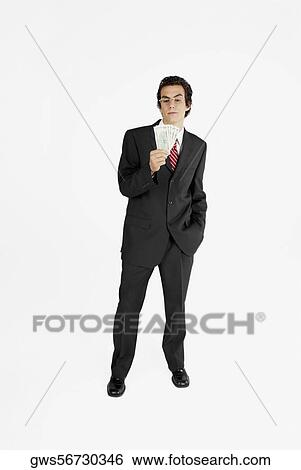 Businessman holding paper currency View Large Photo Image Stock Photograph - Businessman holding paper currency. Fotosearch