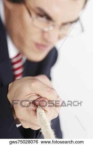 Businessman pulling a rope View Large Photo Image Stock Photograph - Businessman pulling a rope. Fotosearch