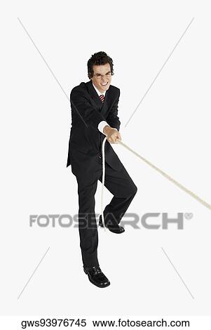 Businessman pulling a rope View Large Photo Image Stock Photography - Businessman pulling a rope. Fotosearch