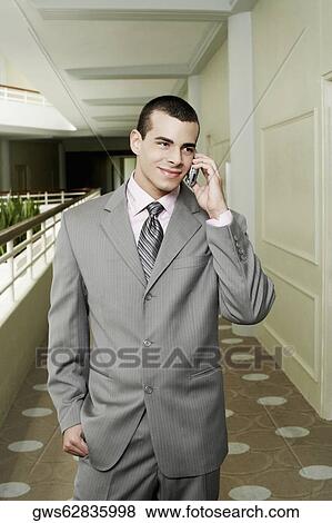 Businessman talking on a mobile phone View Large Photo Image Stock Photo - Businessman talking on a mobile phone. Fotosearch