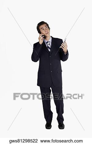 Businessman using a mobile phone View Large Photo Image Stock Image - Businessman using a mobile phone. Fotosearch