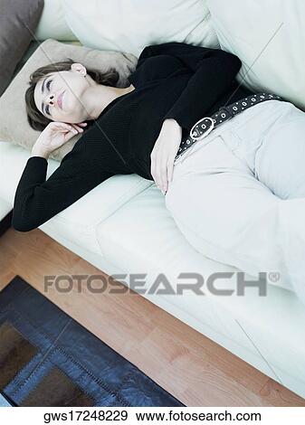Businesswoman lying on a couch View Large Photo Image Stock Photo - Businesswoman lying on a couch. Fotosearch