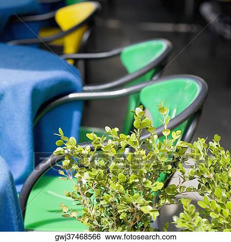Stock Photograph - Chairs and tables at a sidewalk cafe, Venice, Veneto, Italy. Fotosearch