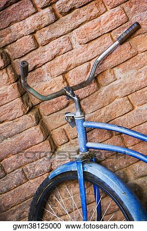Close-up of a bicycle against a brick wall View Large Photo Image Stock Image - Close-up of a bicycle against a brick wall. Fotosearch