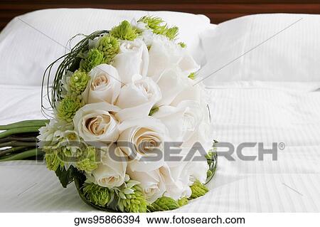Close-up of a bouquet of flowers on the bed View Large Photo Image Picture - Close-up of a bouquet of flowers on the bed. Fotosearch