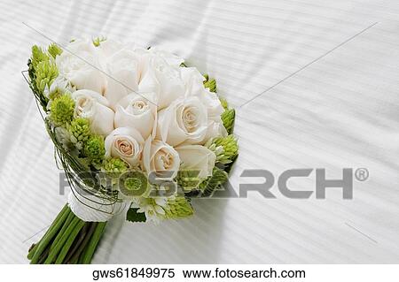 Stock Photography - Close-up of a bouquet of flowers on the bed. Fotosearch