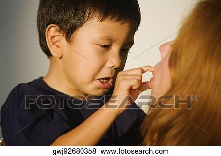 Close-up of a boy and his mother playing View Large Photo Image Stock Photo - Close-up of a boy and his mother playing. Fotosearch