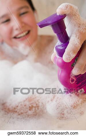 Close-up of a boy holding a soap dispenser in a bathtub View Large Photo Image Stock Photo - Close-up of a boy holding a soap dispenser in a bathtub. Fotosearch