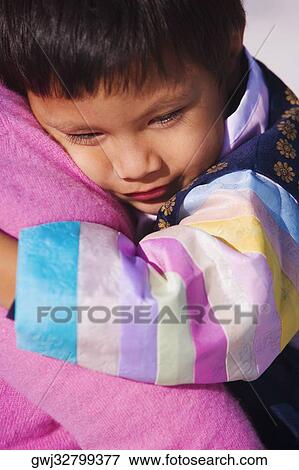 Close-up of a boy hugging a person View Large Photo Image Stock Photo - Close-up of a boy hugging a person. Fotosearch