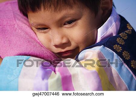 Close-up of a boy hugging a person View Large Photo Image Stock Photograph - Close-up of a boy hugging a person. Fotosearch