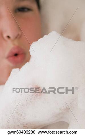 Stock Photo - Close-up of a boy in a bubble bath. Fotosearch