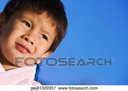 Close-up of a boy in traditional clothing looking away View Large Photo Image Stock Photo - Close-up of a boy in traditional clothing looking away. Fotosearch