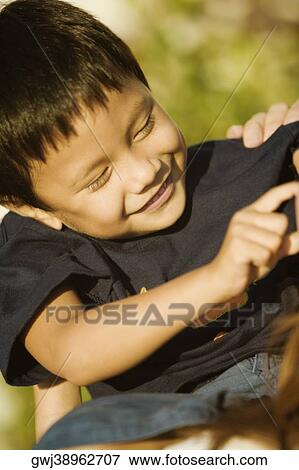 Close-up of a boy playing View Large Photo Image Stock Photo - Close-up of a boy playing. Fotosearch