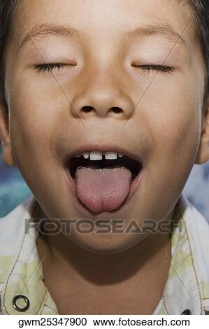 Close-up of a boy with sticking his tongue out View Large Photo Image Stock Image - Close-up of a boy with sticking his tongue out. Fotosearch