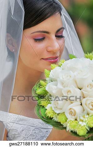Close-up of a bride smelling a bouquet of flowers View Large Photo Image Stock Image - Close-up of a bride smelling a bouquet of flowers. Fotosearch