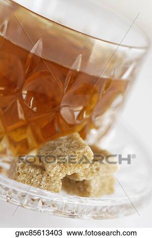Close-up of a brown sugar with a cup of black tea View Large Photo Image Stock Image - Close-up of a brown sugar with a cup of black tea. Fotosearch