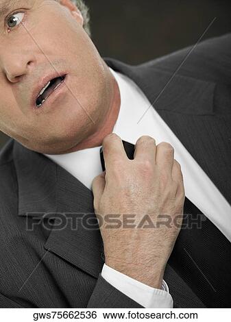 Close-up of a businessman adjusting his tie View Large Photo Image Stock Photograph - Close-up of a businessman adjusting his tie. Fotosearch